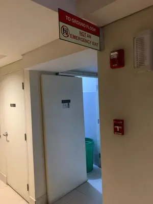 a sign above an emergency room door in a building at Kathys Crib 11th flr at Shell Residence in Manila