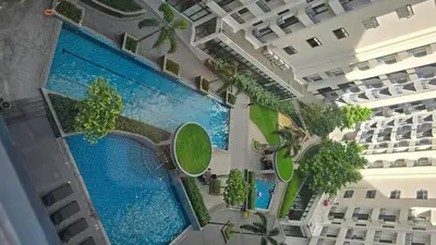 an overhead view of a building with two swimming pools at Ohana Staycation in Manila