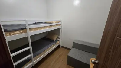 a room with three bunk beds in a room at Ohana Staycation in Manila