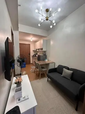 a living room with a couch and a table at Ohana Staycation in Manila