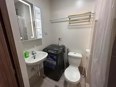 a small bathroom with a toilet and a sink at Ohana Staycation in Manila