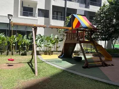 a playground with a slide in front of a building at Ohana Staycation in Manila