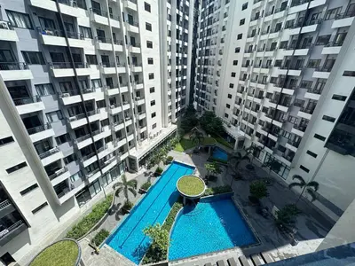 an overhead view of a swimming pool with tall buildings at Ohana Staycation in Manila