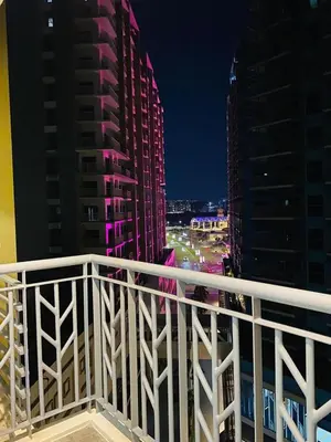 a view of a city at night from a balcony at Savvy Suites 3BR Near Okada in Manila