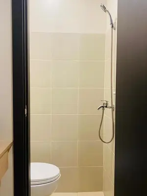 a bathroom with a toilet and a shower at Savvy Suites 3BR Near Okada in Manila