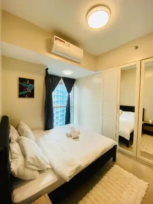 a bedroom with a bed and a window at Serendipity staycation in Manila