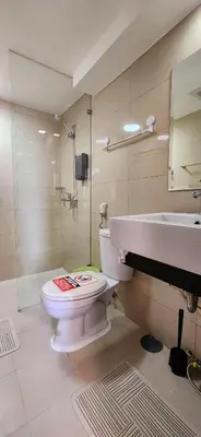 a bathroom with a toilet and a sink at 14F BGC Unit 3 mins Walk to The Venice Grand Canal Mall Pet Friendly in Manila