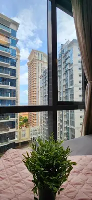 a bedroom with a view of a city from a window at 14F BGC Unit 3 mins Walk to The Venice Grand Canal Mall Pet Friendly in Manila