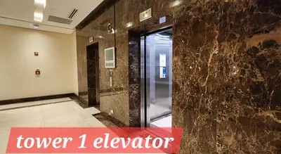 a elevator in a room with a glass door at 14F BGC Unit 3 mins Walk to The Venice Grand Canal Mall Pet Friendly in Manila