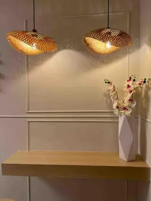a table with two lights and a vase with flowers on it at Stylist hideaway in d heart of MOA in Manila