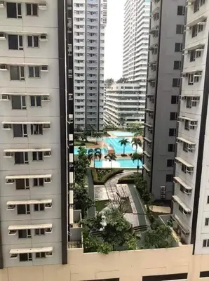 a view of a pool between two tall buildings at S Residence 3,Mall of Asia Area in Manila