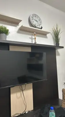 a desk with a clock on top of it at Chays Place in Manila