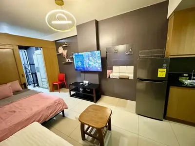 a small room with a bed and a kitchen at Kathys Crib Family Suite Room at Shell Residence in Manila
