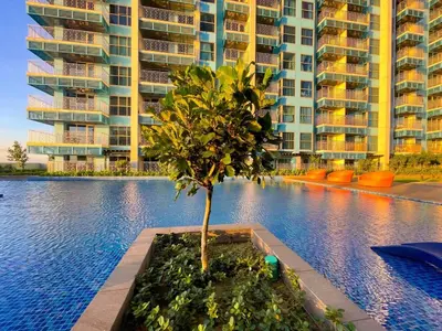 a tree in a planter in front of a building at Luxury Apartment near Okada Manila and Solaire in Manila