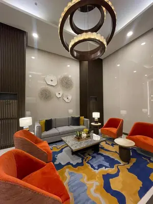 a living room with orange chairs and a large rug at Spacious 3BR condo across Okada Manila and Solaire in Manila