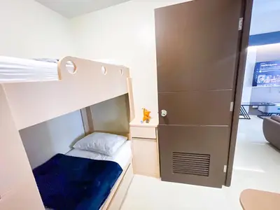 a small bedroom with a bunk bed and a closet at Spacious 3BR condo across Okada Manila and Solaire in Manila