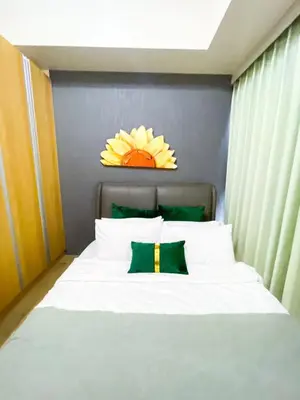a bedroom with a white bed with a flower above it at Spacious 3BR condo across Okada Manila and Solaire in Manila