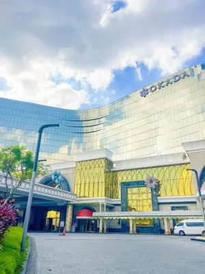 a large building with a sign on the side of it at Luxury 1BR across Okada, Solaire in Manila