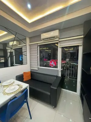 a living room with a black couch and a window at Kys 3 staycation near NAIA mall of asia in Manila