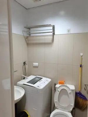 a small bathroom with a toilet and a sink at Kys 4 staycation mall of asia in Manila