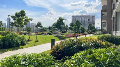 a park with bushes and flowers in a city at Jungle Escape in Manila