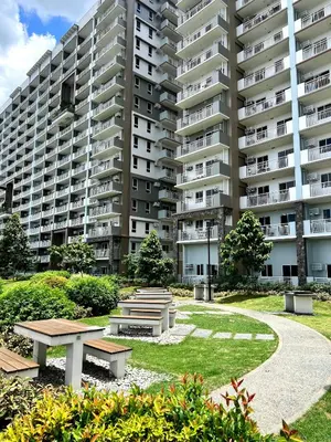a park in front of a large apartment building at Jungle Escape in Manila