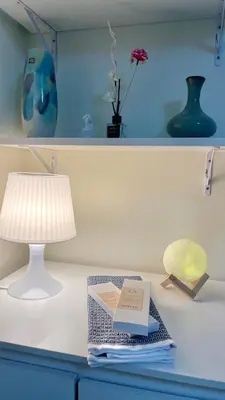 a table with a lamp and a book on it at Jungle Escape in Manila