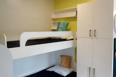a room with two bunk beds and a cabinet at Elegant Studio at Ortigas Business District, Pasig City in Manila