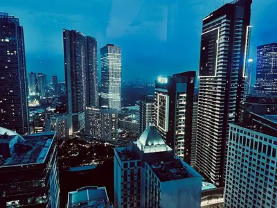 a city skyline at night with tall buildings at Elegant Studio at Ortigas Business District, Pasig City in Manila