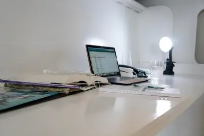 a laptop computer sitting on top of a table at Elegant Studio at Ortigas Business District, Pasig City in Manila