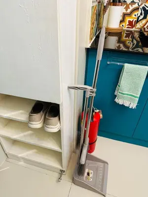 a vacuum cleaner in a kitchen next to a refrigerator at Elegant Studio at Ortigas Business District, Pasig City in Manila
