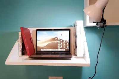 a laptop computer sitting on a shelf with a wii at Elegant Studio at Ortigas Business District, Pasig City in Manila