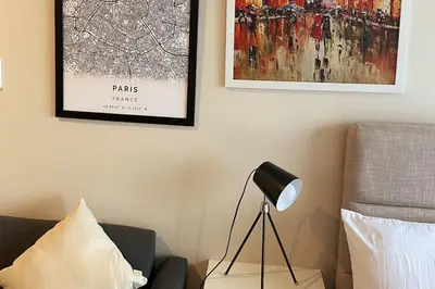 a lamp sitting on a table next to a couch at Cosmopolitan Comfort Makati 1 BR Wonder 300MB 2428 Internet in Manila