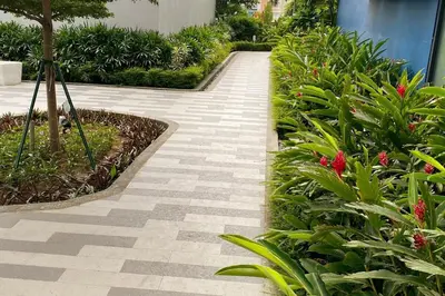 a walkway in a garden with flowers and plants at Cosmopolitan Comfort Makati 1 BR Wonder 300MB 2428 Internet in Manila
