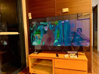 a flat screen tv sitting on top of a wooden stand at 3 Bedroom Air condo Pool Perfect Holiday Gym Swim 300 Mbps in Manila