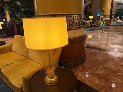 a yellow lamp sitting on a table next to a couch at 3 Bedroom Air condo Pool Perfect Holiday Gym Swim 300 Mbps in Manila