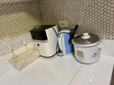 a counter with two toasters and a toaster and a coffee maker at 3 Bedroom Air condo Pool Perfect Holiday Gym Swim 300 Mbps in Manila