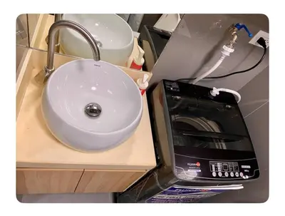 a sink in a counter next to a microwave at Chic Luxury Air condo 2 Bedroom Finest City Living Air Makati Gym Swim Park 300 in Manila