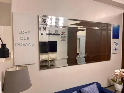 a mirror on a wall in a living room at Cruise Ship Condo Escape Makati 300 Mbps Gym Swim Park 2271 in Manila