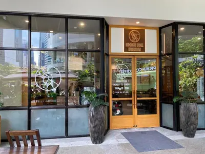 a restaurant with plants in front of a glass door at Cruise Ship Condo Escape Makati 300 Mbps Gym Swim Park 2271 in Manila