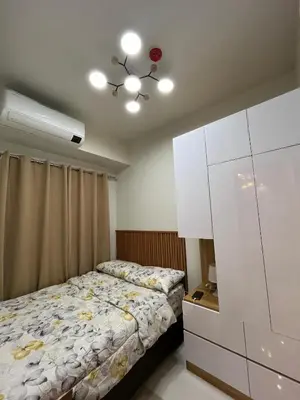 a bedroom with a bed and a dresser at Dahl's Cozy Place in Manila