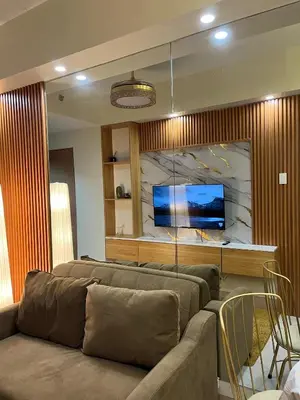 a living room with a couch and a tv at Dahl's Cozy Place in Manila
