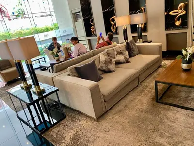 a living room with a couch and people in a room at Heavenly holiday Italian Rome Air Makati Gym Swim Park 300 in Manila