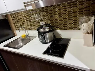 a kitchen counter with a toaster and a sink at Heavenly holiday Italian Rome Air Makati Gym Swim Park 300 in Manila
