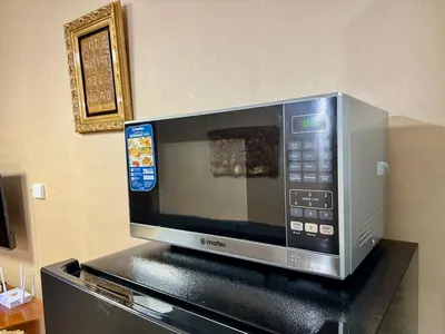 a microwave oven sitting on top of a counter at Heavenly holiday Italian Rome Air Makati Gym Swim Park 300 in Manila