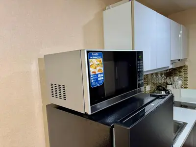 a microwave oven sitting on top of a kitchen counter at Heavenly holiday Italian Rome Air Makati Gym Swim Park 300 in Manila