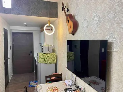 a kitchen with a guitar hanging on the wall at Jazz Air Rooftop Penthouse Bar Gym Swim Park 300 Mbps Air 4034 in Manila