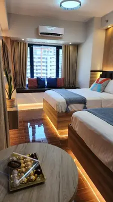 a hotel room with two beds and a tray of food at Air residence Fantasy Sophisticated Heaven on earth Gym Swim Park 300 MB in Manila