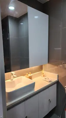 a bathroom with a white sink and a mirror at Air residence Fantasy Sophisticated Heaven on earth Gym Swim Park 300 MB in Manila
