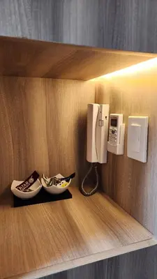a phone on a wall with a bowl on a shelf at Air residence Fantasy Sophisticated Heaven on earth Gym Swim Park 300 MB in Manila